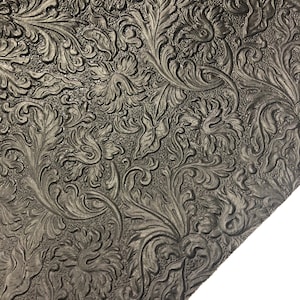 May include: Black embossed leather fabric with a floral pattern.