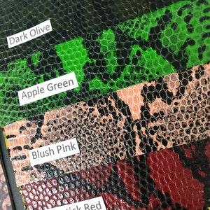 May include: Close-up of five different colored swatches of faux snakeskin fabric. The swatches are labeled "Dark Olive", "Apple Green", "Blush Pink", "Lipstick Red", and "Yellow".