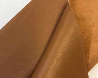 May include: Two pieces of brown leather, one with a smooth finish and the other with a textured finish.