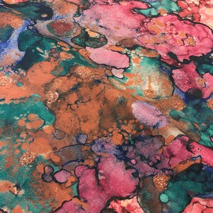 May include: Abstract art print with a marbled design in shades of pink, teal, brown, and gold.