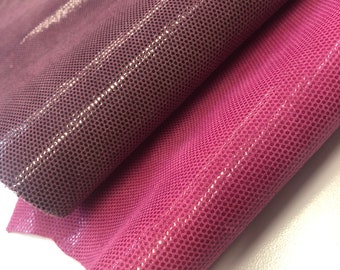 May include: Two pieces of pink and mauve textured leather with a pebbled pattern.