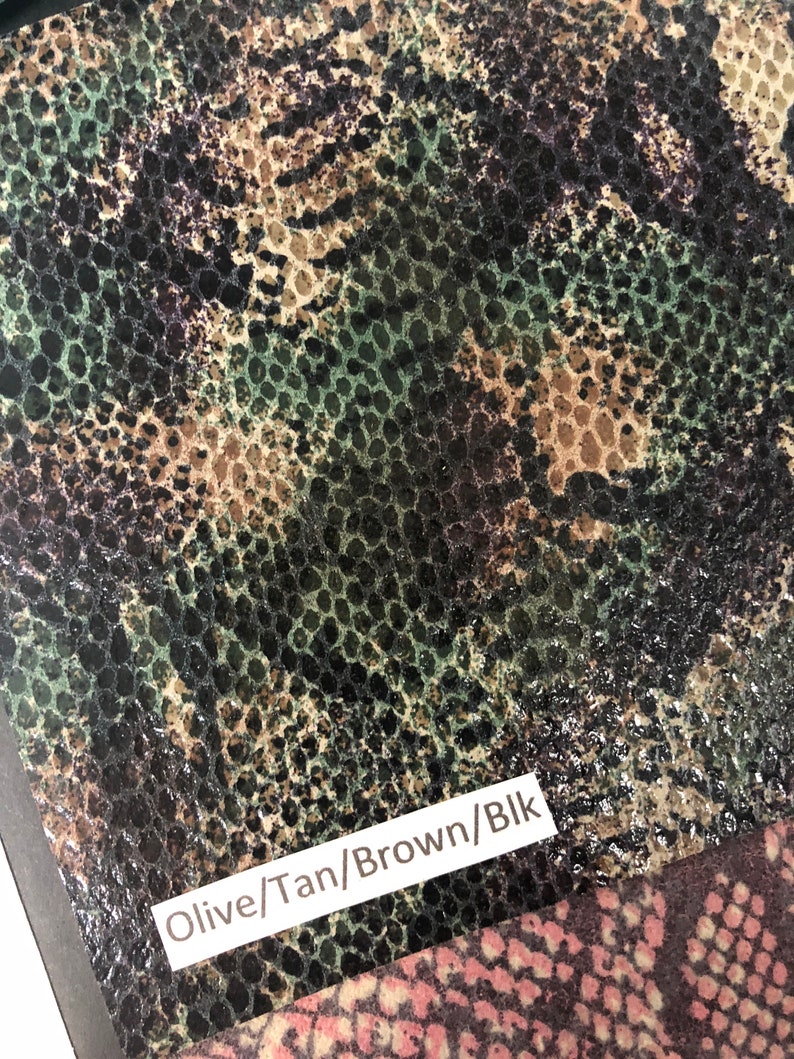 May include: Close-up of a fabric with a snakeskin pattern in shades of olive green, tan, brown, and black. The fabric is labeled "Olive/Tan/Brown/Blk".