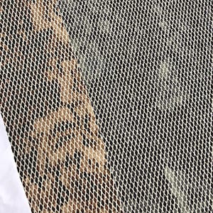 May include: A close-up of two pieces of fabric with a woven mesh pattern. One piece is a light brown color and the other is a dark gray color.