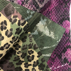May include: A close-up of three fabric swatches with different animal print patterns. The swatches are a green and brown camouflage print, a purple and black snake skin print, and a green and silver fishnet print.