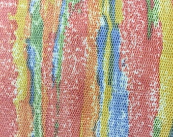 May include: Abstract colorful fabric with a textured, scaly pattern. The fabric features a repeating pattern of blue, green, yellow, and red.