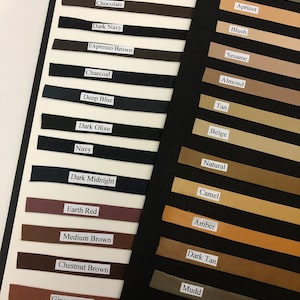 May include: A color chart of leather swatches with names for each color. The colors range from black to deep tan on the left side and from taupe to milk chocolate on the right side.