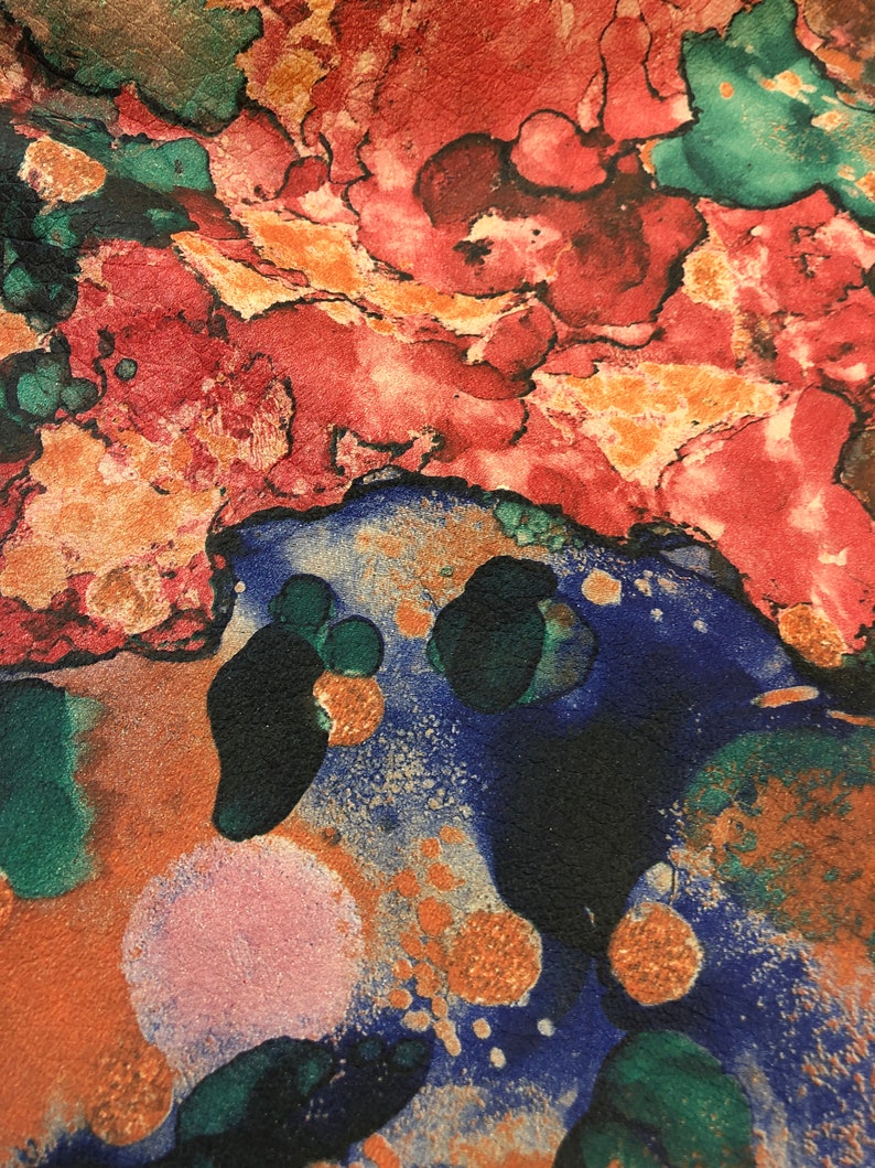 May include: Abstract art print with a colorful, marbled design. The print features shades of red, orange, green, blue, and gold.