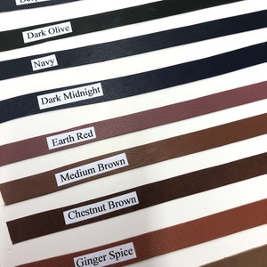 May include: A selection of leather straps in various colors, including charcoal, deep blue, dark olive, navy, dark midnight, earth red, medium brown, chestnut brown, ginger spice, and deep tan.