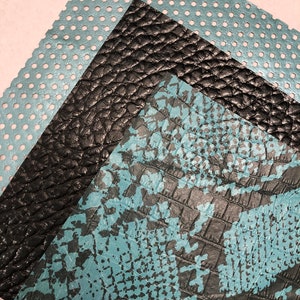 May include: Three different textured fabric swatches. The top swatch is a light blue perforated fabric. The middle swatch is a black textured fabric. The bottom swatch is a light blue and black textured fabric.