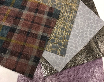May include: Five different fabric swatches with various textures and patterns. The swatches include a plaid pattern, a crocodile skin pattern, a gray fabric with small circles, a silver glitter fabric, and a purple glitter fabric.