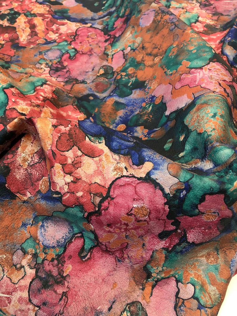 May include: Abstract floral fabric with a watercolor-like design in shades of pink, blue, green, and brown.