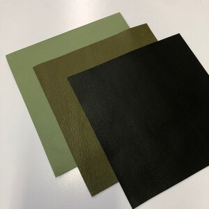 May include: Three fabric swatches in different shades of green and black. The swatches are arranged in a stack, with the lightest green on top and the black on the bottom.