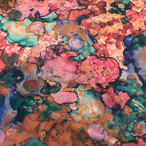 May include: Abstract art print with a colorful, marbled design in shades of pink, blue, green, and brown. The print features a swirling, organic pattern with a metallic gold finish.