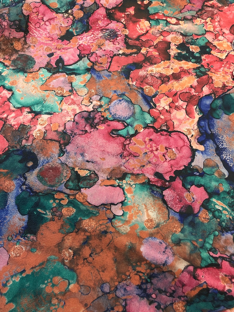 May include: Abstract art print with a colorful, marbled design in shades of pink, blue, green, and brown. The print features a swirling, organic pattern with a metallic gold finish.