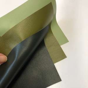 May include: Three pieces of faux leather in different shades of green. The top piece is a light green, the middle piece is a darker green, and the bottom piece is a black green.
