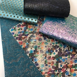 May include: Five different pieces of leather fabric in various colors and patterns. The fabrics include a teal blue with a wavy pattern, a white fabric with a floral pattern, a teal blue fabric with a polka dot pattern, a black fabric with a textured pattern, and a teal blue fabric with a floral pattern.