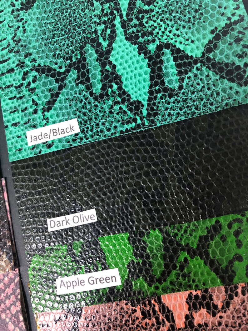 May include: Close-up of three different colored faux snakeskin fabric swatches. The swatches are labeled "Jade/Black", "Dark Olive", and "Apple Green".