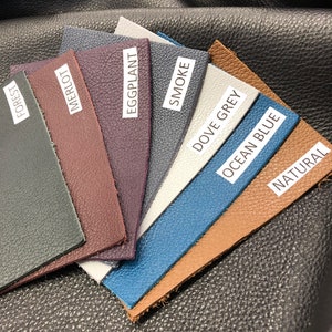 May include: Leather swatches in various colors, including forest, merlot, eggplant, smoke, dove grey, ocean blue, and natural.