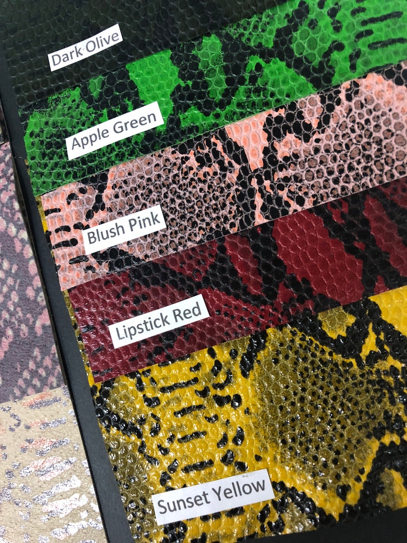 May include: Close-up of five different colored faux snakeskin fabric swatches. The swatches are labeled "Dark Olive", "Apple Green", "Blush Pink", "Lipstick Red", and "Sunset Yellow".