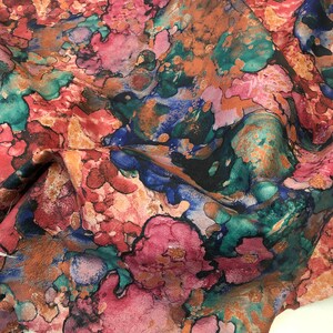 May include: Abstract floral print fabric with a watercolor effect in shades of pink, blue, green, and brown.