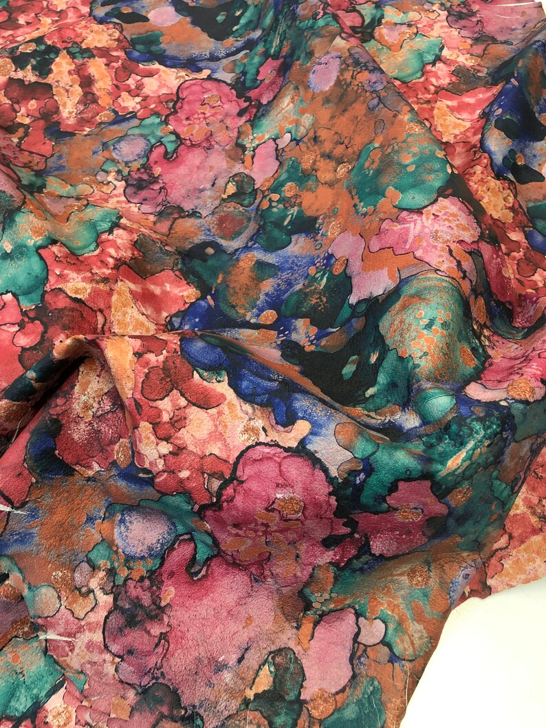 May include: Abstract floral print fabric with a watercolor effect in shades of pink, blue, green, and brown.