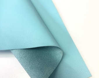 May include: A piece of light blue faux leather with a textured surface.
