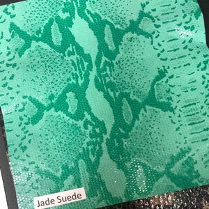 May include: A close-up of a jade green snakeskin fabric swatch with the text "Jade Suede" printed on a white label.
