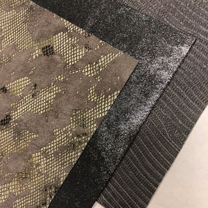 May include: Three fabric swatches in different textures and colors. The first swatch is a light brown with a snakeskin pattern. The second swatch is a dark gray with a subtle glitter finish. The third swatch is a dark gray with a textured woven pattern.