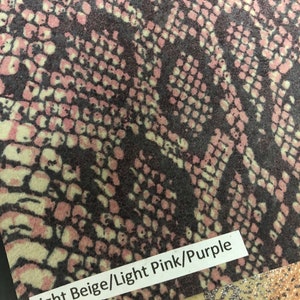 May include: Close-up of a fabric swatch with a snakeskin pattern in light beige, light pink, and purple. The text "Light Beige/Light Pink/Purple" is printed on the fabric.