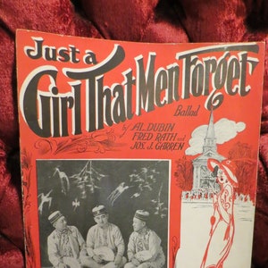 May include: Vintage sheet music cover titled "Just a Girl That Men Forget." The red cover features a black and white photo of three men and an illustration of a woman. The text includes the names of the songwriters and the group "Chung Hwa Three."