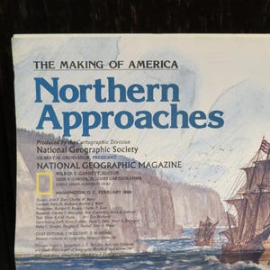 May include: A vintage National Geographic Magazine cover titled "Northern Approaches" with a nautical illustration. The cover features text in blue and white, with a depiction of sailing ships and coastal cliffs. The magazine is from February 1961.