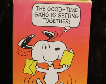 May include: A package of Hallmark invitations featuring Snoopy from the Peanuts comic strip. The image shows Snoopy holding invitations with the text "THE GOOD-TIME GANG IS GETTING TOGETHER!" on a red and orange background.