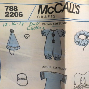 May include: A McCall's Crafts sewing pattern featuring doll costume designs. The pattern includes illustrations for a clown costume with a jumpsuit, hat, and collar, and an angel costume. The pattern number is 788 2206.