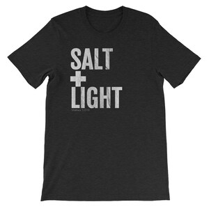 May include: A black t-shirt with white text that reads "SALT + LIGHT" and "Matthew 5:13-16".