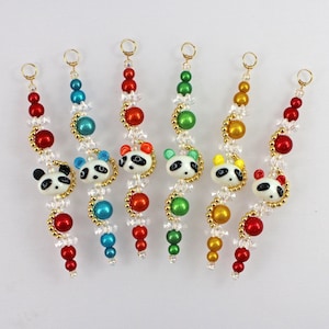 May include: Seven beaded necklaces with panda bear charms. Each necklace features a different color scheme: red, green, blue, yellow, and white.