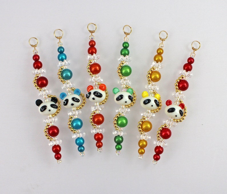 May include: Seven beaded necklaces with panda bear charms. Each necklace features a different color scheme: red, green, blue, yellow, and white.