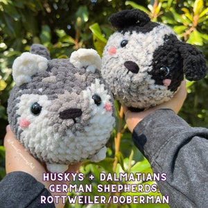 May include: Two plush dog toys, one a husky with gray, white, and black yarn, the other a Dalmatian with black and white yarn. Both have black eyes and pink cheeks. The text at the bottom reads "HUSKYS + DALMATIANS GERMAN SHEPHERDS, ROTTWEILER/DOBERMAN."