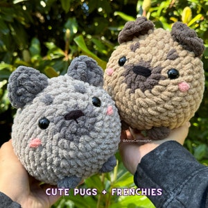 May include: Two handmade crochet pug dog plushies. One is gray, the other is tan. Both have black eyes, pink cheeks, and dark brown noses. The text "CUTE PUGS + FRENCHIES" is at the bottom of the image.