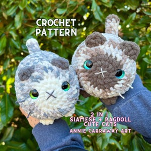 May include: Crochet pattern for two amigurumi cats, a Siamese and a Ragdoll. The Siamese cat is gray and white with green eyes, and the Ragdoll cat is brown and white with blue eyes. The pattern is by Annie Carraway Art.