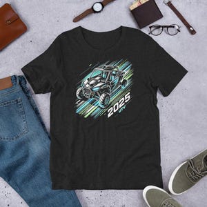 May include: A dark heather grey t-shirt featuring a graphic of a black 2025 UTV on a blue and green background.