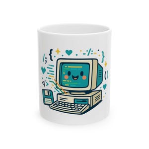 May include: A white ceramic mug featuring a colourful graphic of a smiling vintage computer with a screen displaying code. The design includes a floppy disk, various programming symbols like brackets and hearts, and yellow star accents.