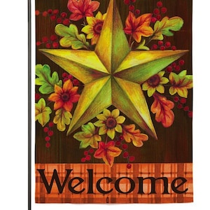 May include: A welcome garden flag with a large yellow star surrounded by fall leaves and flowers. The flag has a brown background with a plaid border and the word "Welcome" in black text.