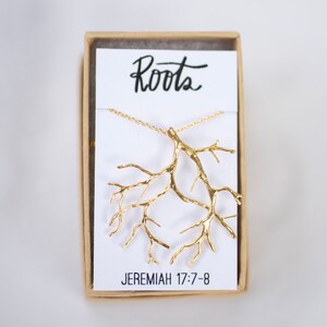 May include: Gold necklace with a tree root pendant and a card that says "Roots" and "Jeremiah 17:7-8".