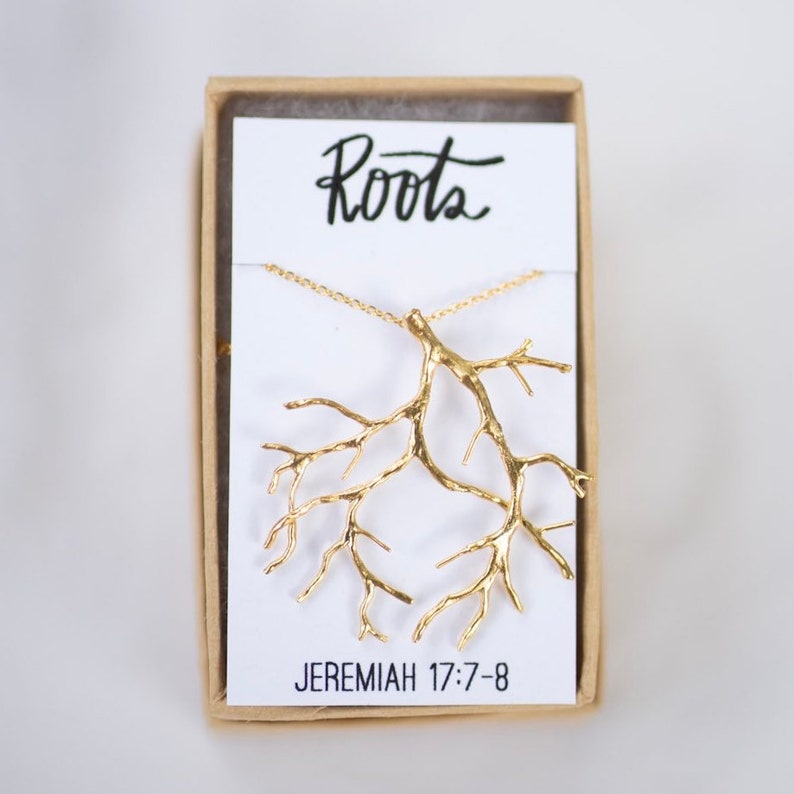 May include: Gold necklace with a tree root pendant and a card that says "Roots" and "Jeremiah 17:7-8".