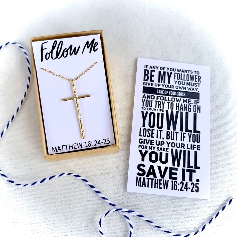 May include: Gold cross necklace in a box with a card that reads "If any of you wants to be my follower you must give up your own way. Take up your cross and follow me. If you try to hang on to your life you will lose it, but if you give up your life for my sake you will save it. Matthew 16:24-25"