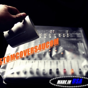 May include: A clear plastic cover is being placed over a white audio mixing board. The cover is water-resistant and protects the board from spills and dust. The text "CUSTOMCOVERS4U.COM" is printed in orange on the cover. The text "MADE IN USA" is printed in blue on a chain link design at the bottom of the image.