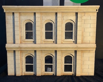 May include: A detailed miniature building model in a 1/12th scale, featuring a light beige brick facade and arched windows. The image includes the text "1/12th Scale Miniature". A green circle states "FREE SHIPPING".