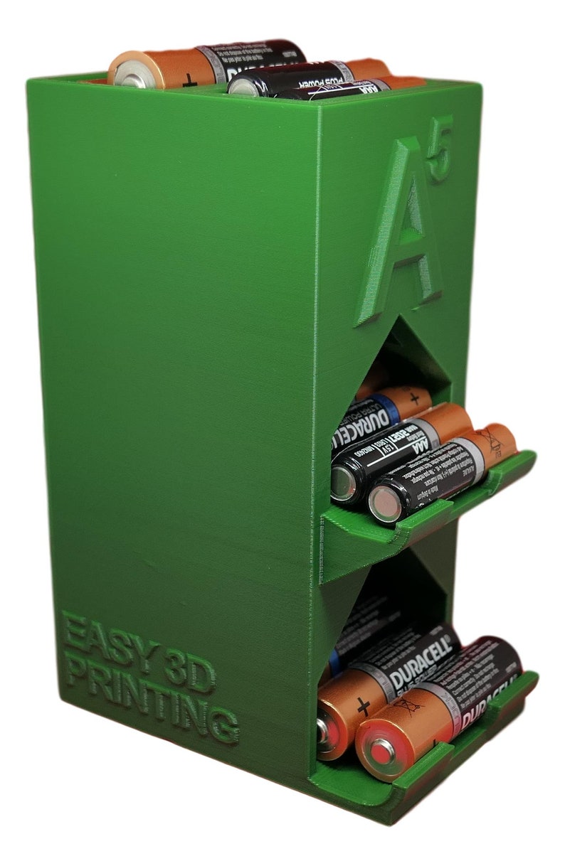 May include: Green 3D printed battery organiser with slots for AA batteries. The organiser has the text "EASY 3D PRINTING" and "A5" on the front.