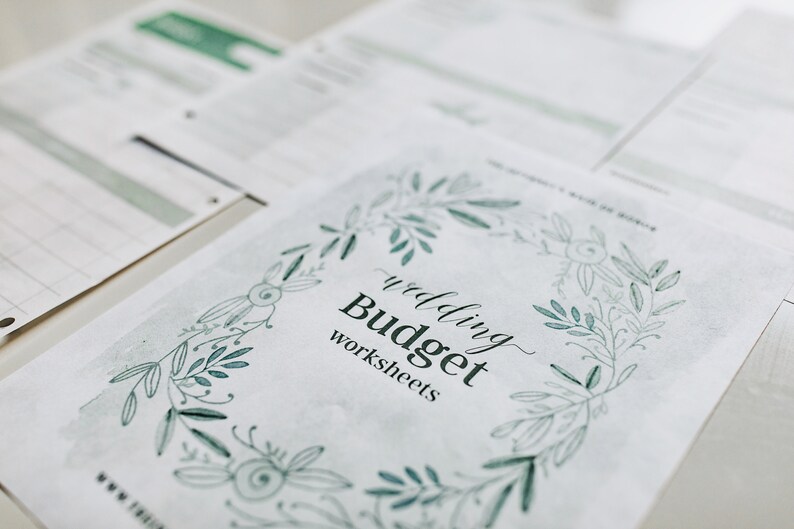May include: A white sheet of paper with a green floral border and the text "wedding Budget worksheets".