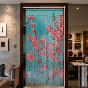 May include: A beaded curtain featuring a turquoise background with a printed design of pink cherry blossom branches. The curtain consists of numerous vertical strands of small beads that form a cohesive floral image across the doorway.